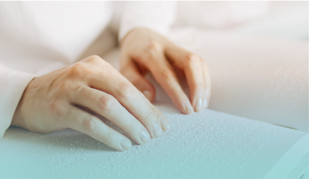 Close-up of hands reading and tracing Braille text, showcasing the tactile language for the visually impaired. Provided by Home Not Alone Caregiver Services for individuals with intellectual disability (IDD) within Community for Disabled Adults and accessible family group homes in Allegheny County, Pittsburgh, Pennsylvania.